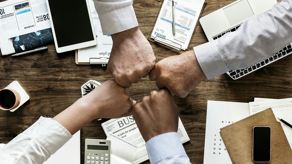 Hands together showing business teamwork